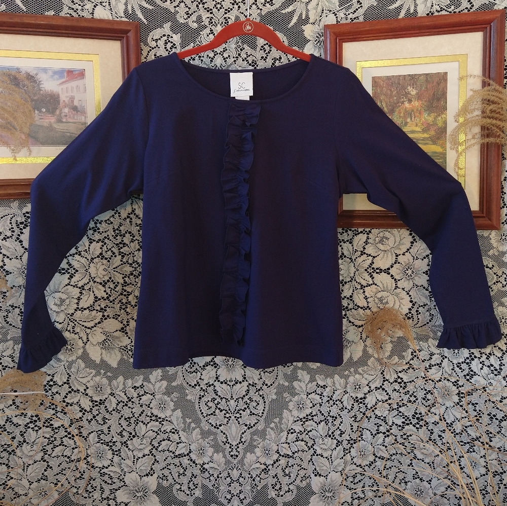 Sara Campbell dark blue long sleeve shirt with ruffles on front and sleeve cuffs